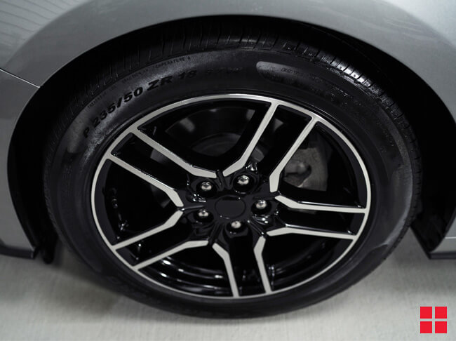 Tire with shiny rubber after Wipe New is applied.