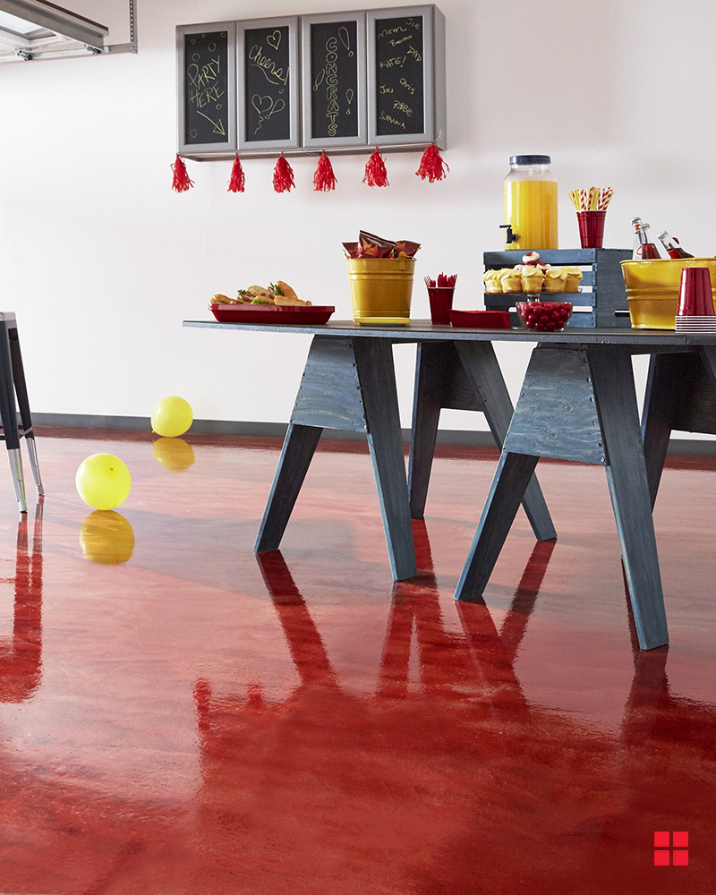 Table with food on a glossy red garage floor.
