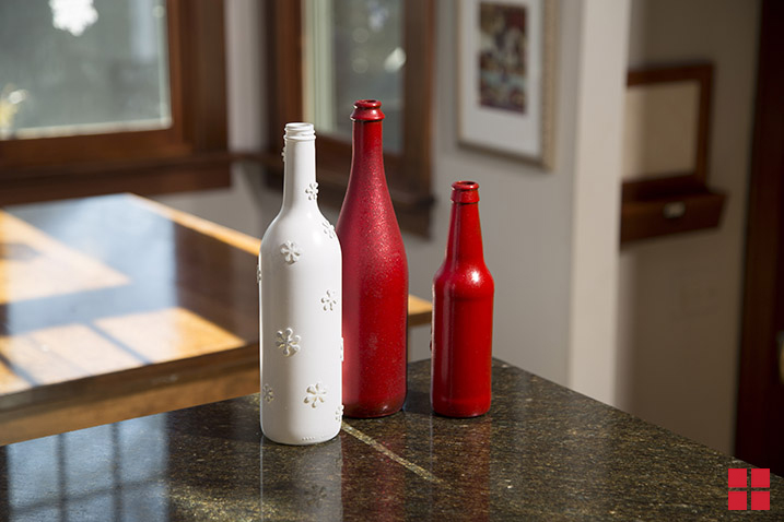 Glass bottles painted red and white.