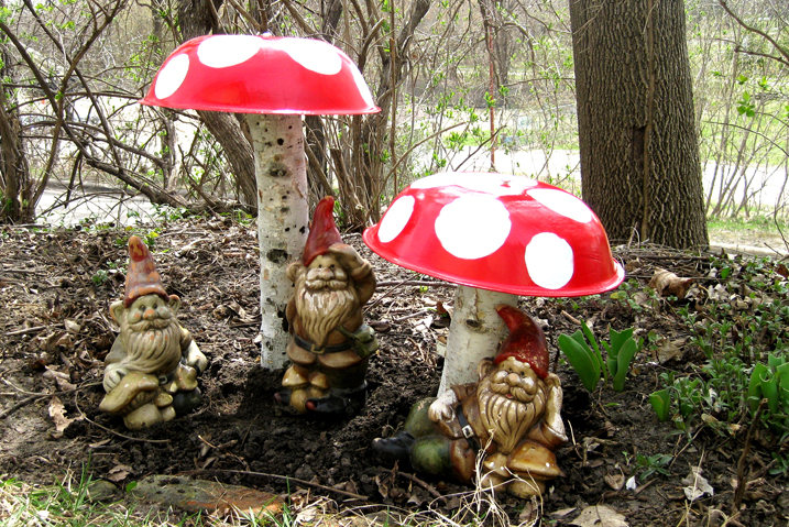 mushrooms made from old large bowls and logs with Gnomes around