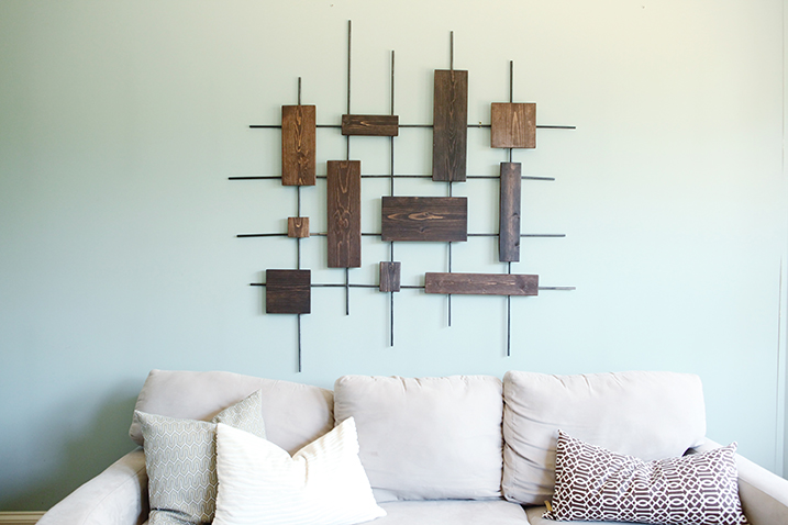 Wall art constructed of wooden boards and metal dowel rods