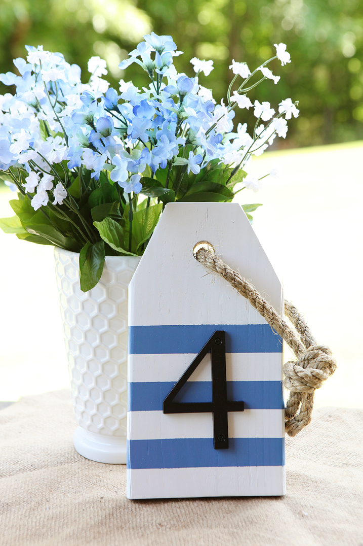 table number made from wood tag painted white with blue stripes and house number screwed on