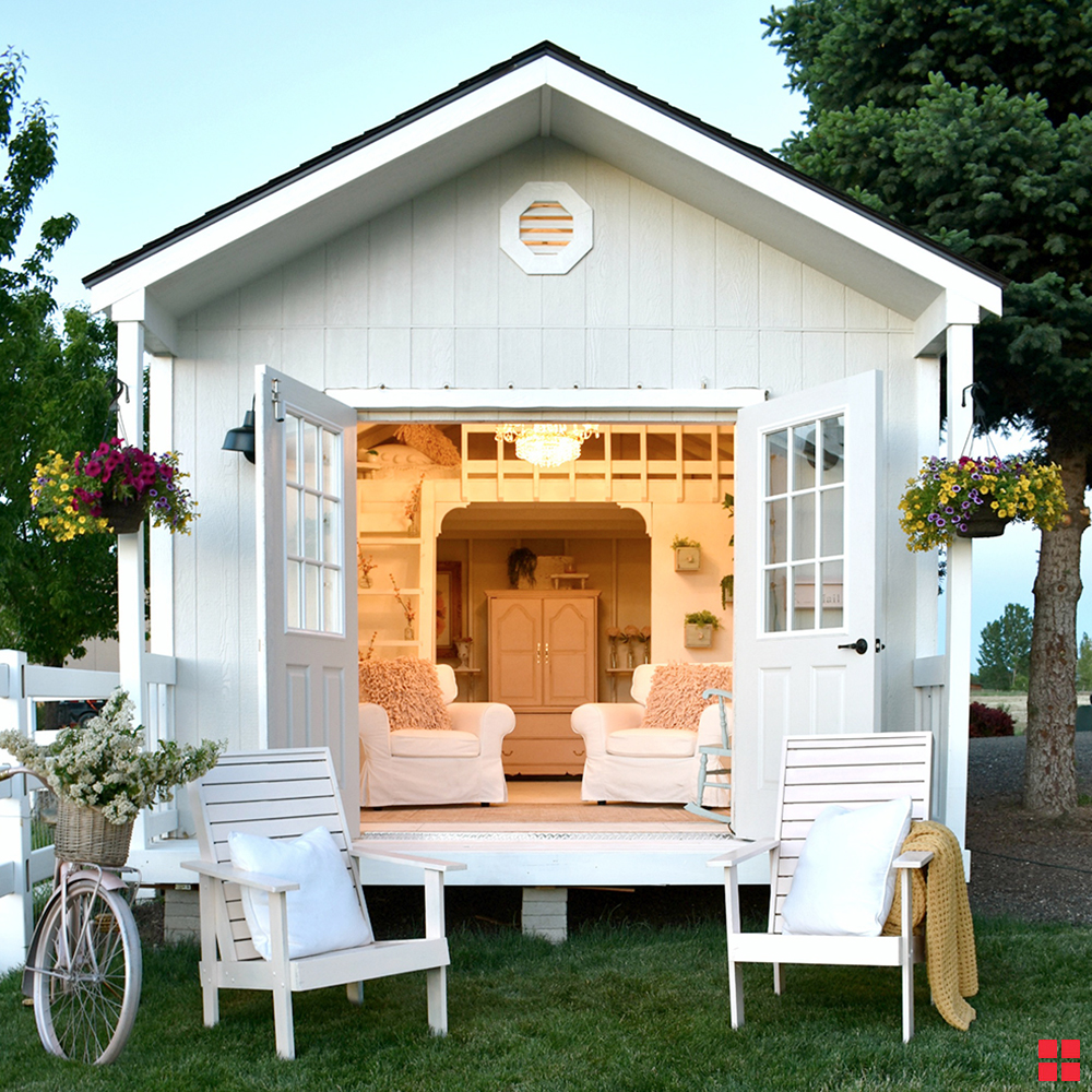 Doors open on a white “she shed.”