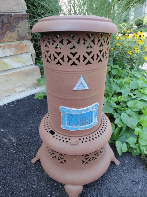 antique oil burner now a plant stand