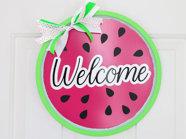 Pizza pan door wreath painted as a watermelon. 