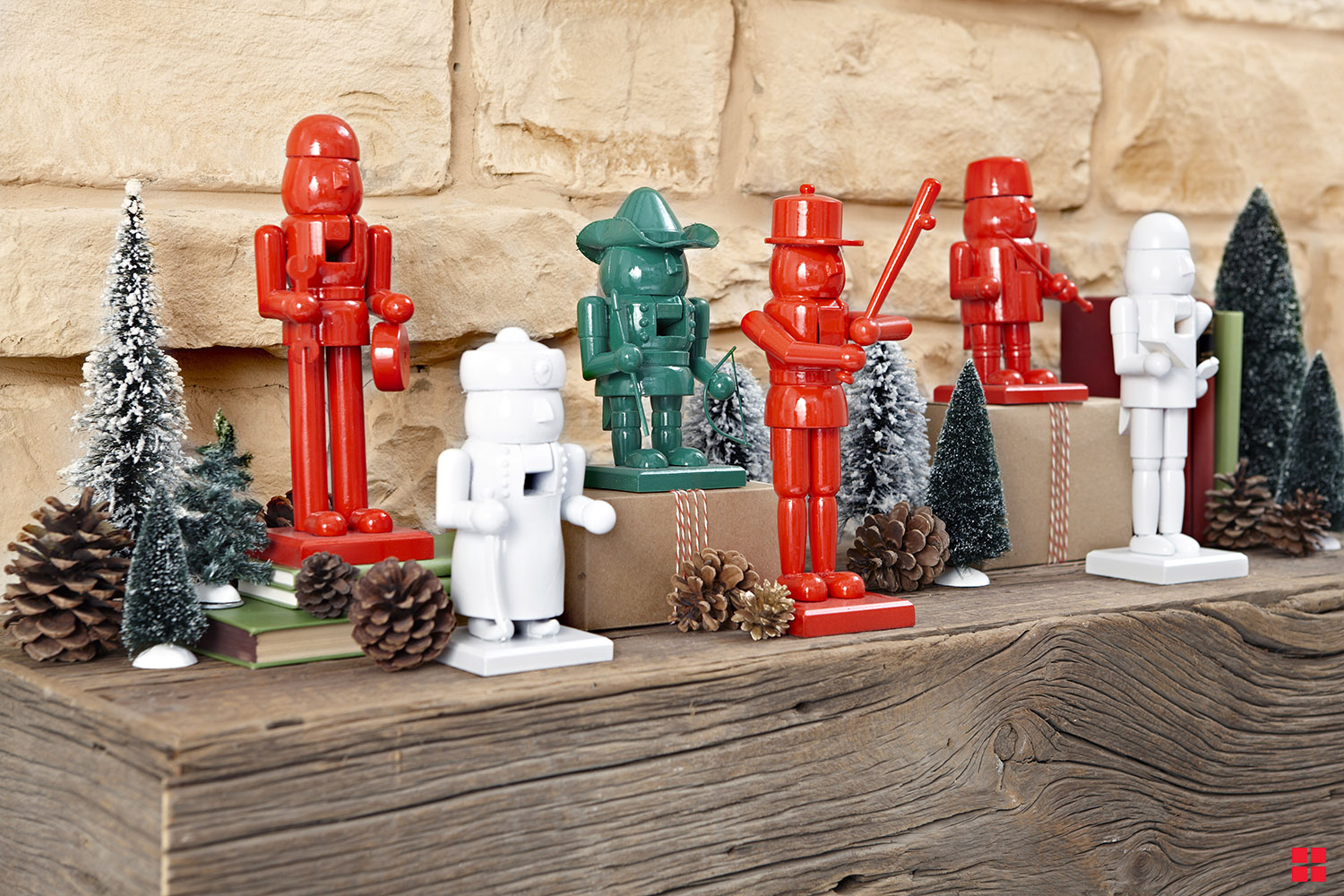 Christmas nutcrackers painted in solid red, green and white and displayed on a mantle.