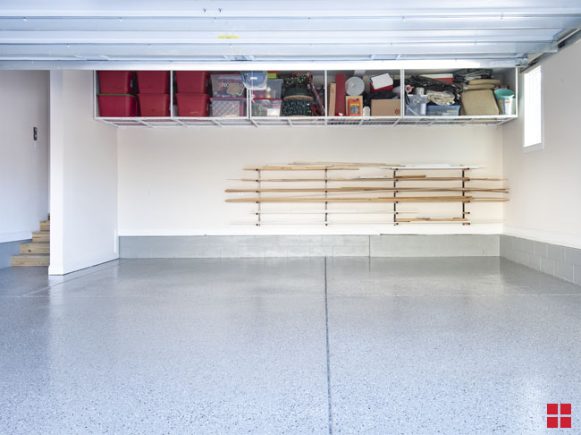 A garage with a shiny gray floor and black and white speckles.