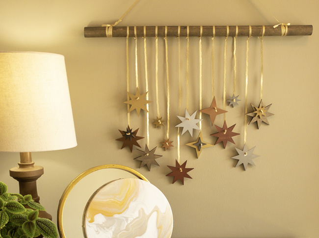 Hanging wall décor featuring metallic painted stars. 