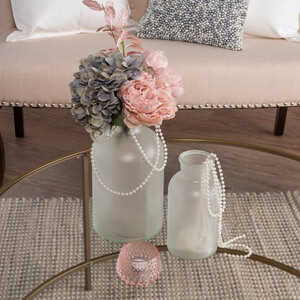 Frosted glass vases decorated with pearls and flowers.
