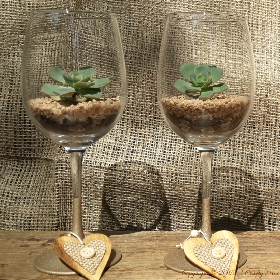 Two plain wine glasses next to a can of Rust-Oleum MultiColor Textured Spray Paint and other craft supplies.