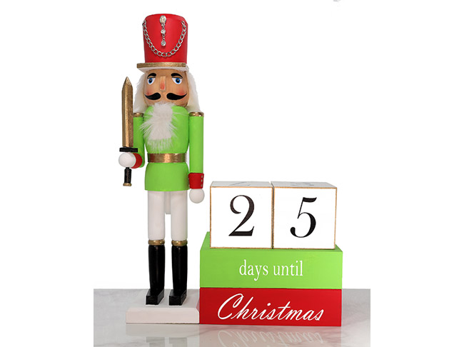 A red and green Nutcracker figurine next to wooden blocks that say 25 days until Christmas.