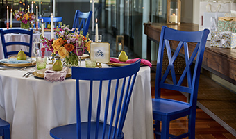 Blue chairs close to table at wedding