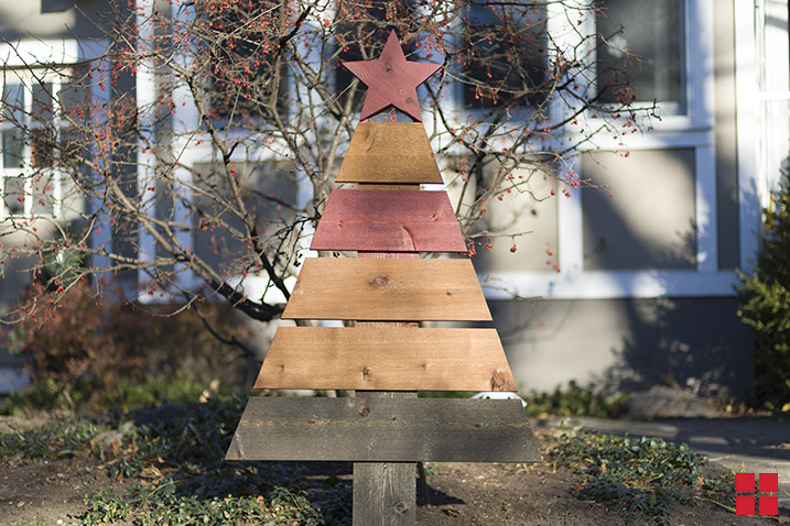 A Christmas tree built from different colored wood planks and a red star on top. 