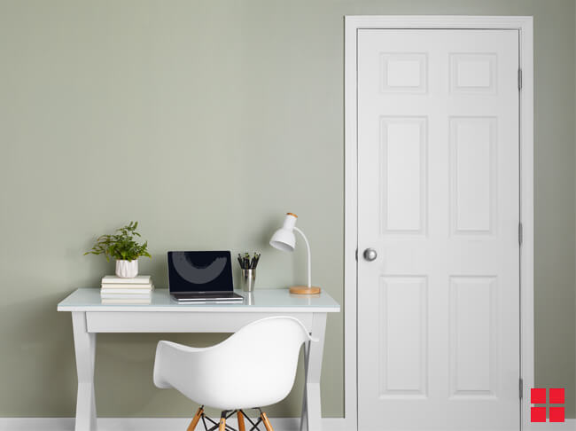 White desk against a white wall.