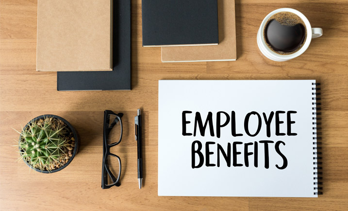 Employee benefits notebook, glasses and pen. 