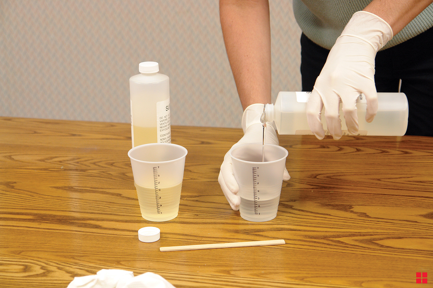 Measuring cups with Super Glaze resin and Super Glaze activator.