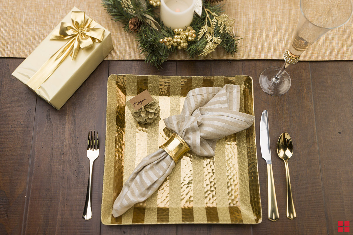 Place setting with glitter stipes painted on a plate charger.