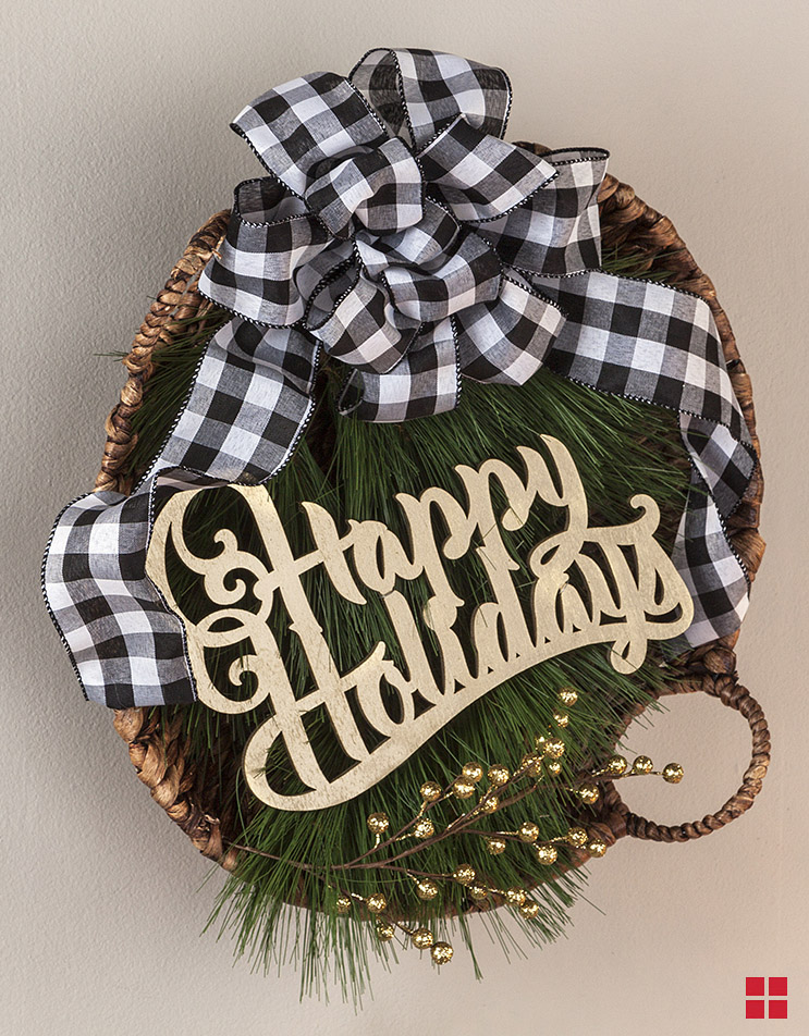 Wreath with “happy holidays” wood cutout in the middle.