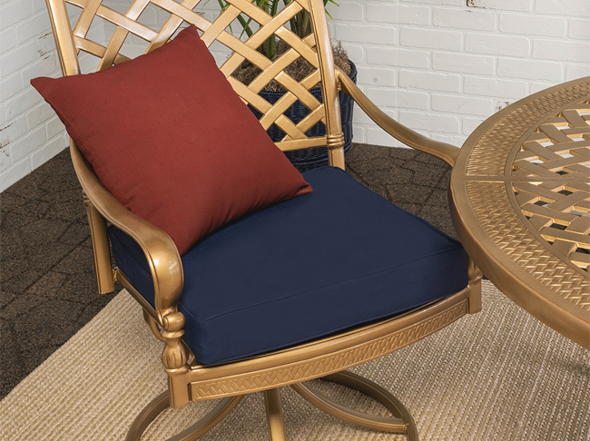 Patio chair with a blue cushion and red pillow.